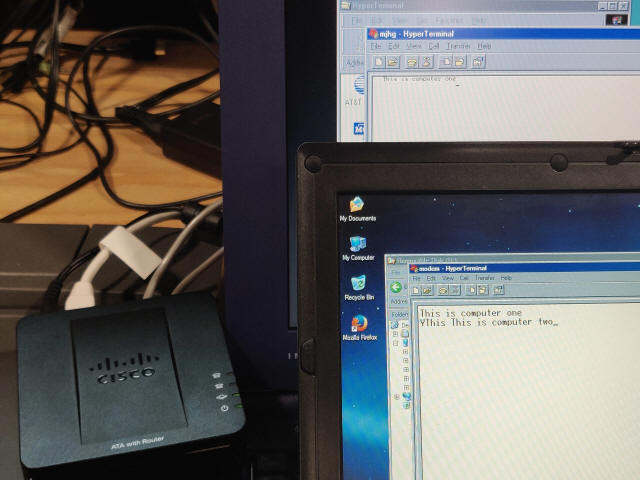 Two laptops connected via modem over a VoIP ATA