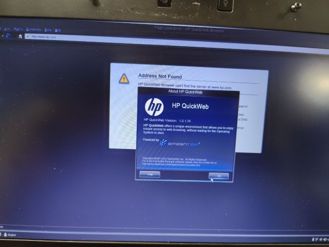 Photo of a laptop running HP QuickWeb, showing the about page for a web browser that takes up the whole screen