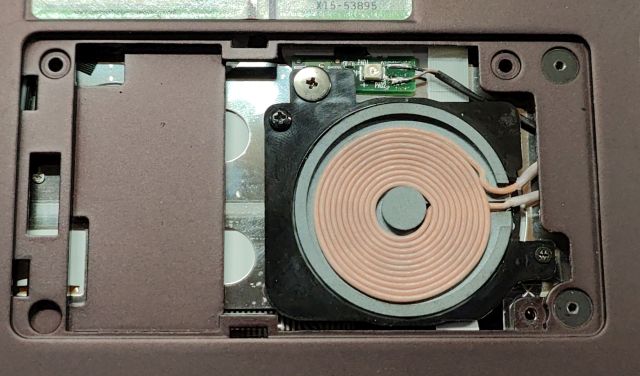 A closeup of the underside of the Z600, with a small plastic cover removed to reveal a spirally wound copper coil