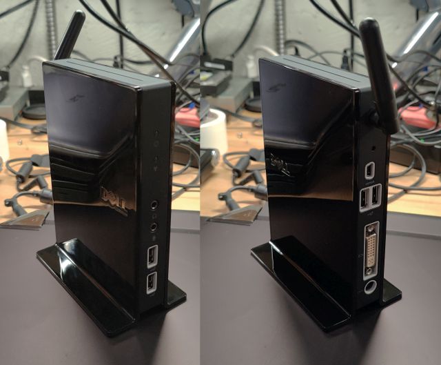 Side by side shot of the front and back of the Dell wireless dock. The front has two USB ports and speaker/microphone jacks; the back, a short antenna, two more USB ports, a smaller mini-USB port labeled SYNCH, a pinhole reset button, and a DVI port